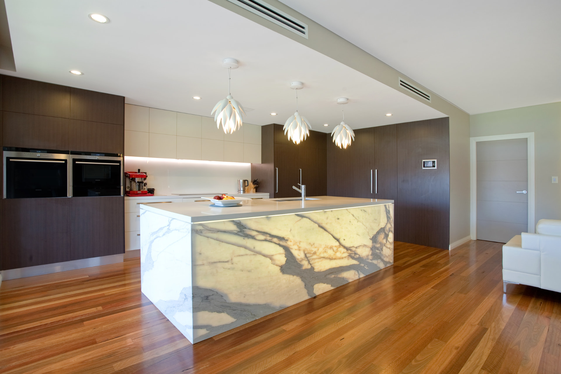 Kellyville — Kitchen with lit marble island and timber flooring