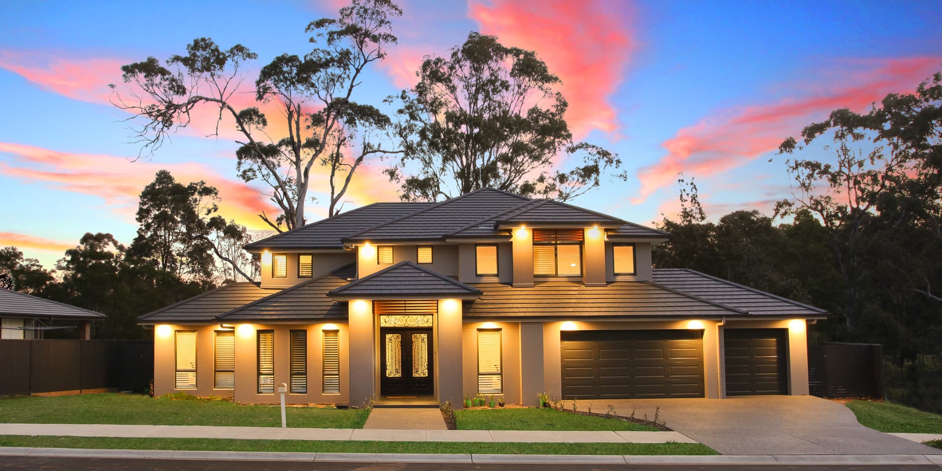 Bella Vista — Rendered two-storey residence at dusk with a three-car garage